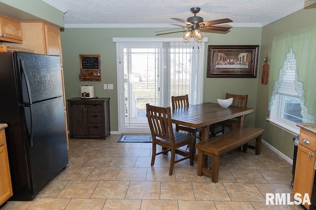 dining area featuring ornamental molding, ceiling fan, a textured ceiling, and baseboards