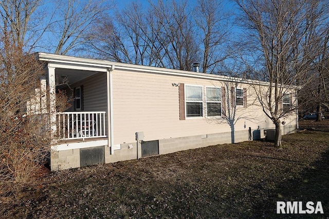 view of home's exterior featuring central AC unit and a porch