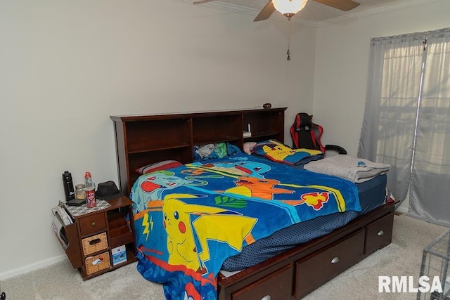 carpeted bedroom with ornamental molding and ceiling fan