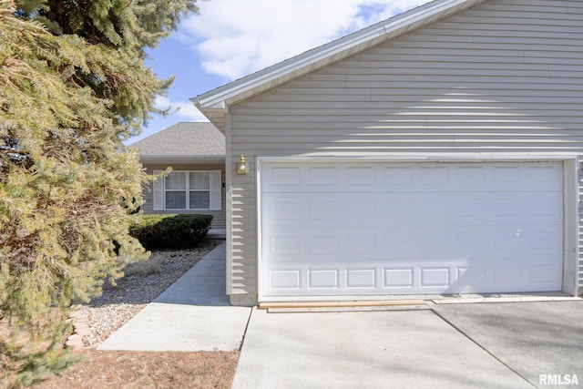 garage featuring concrete driveway