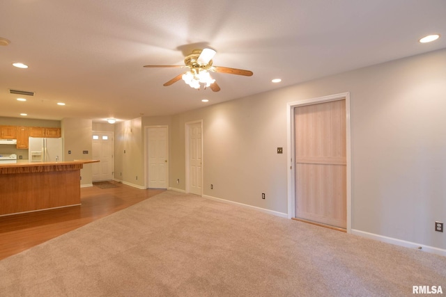 unfurnished living room with light carpet, baseboards, visible vents, and recessed lighting