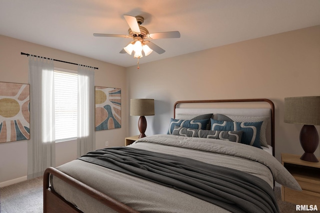 carpeted bedroom with a ceiling fan and baseboards