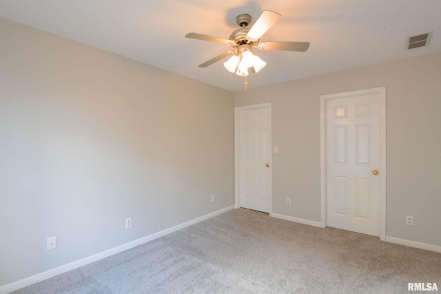 unfurnished room with a ceiling fan, carpet, visible vents, and baseboards