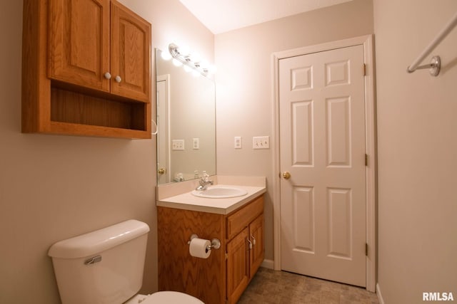 half bathroom with vanity and toilet