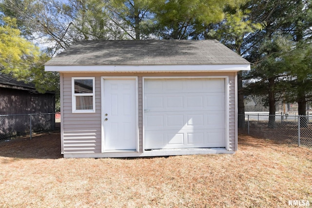 detached garage featuring fence