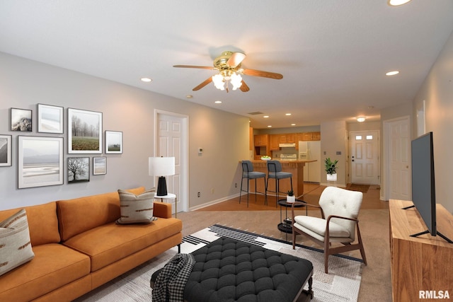 living area featuring baseboards, a ceiling fan, and recessed lighting