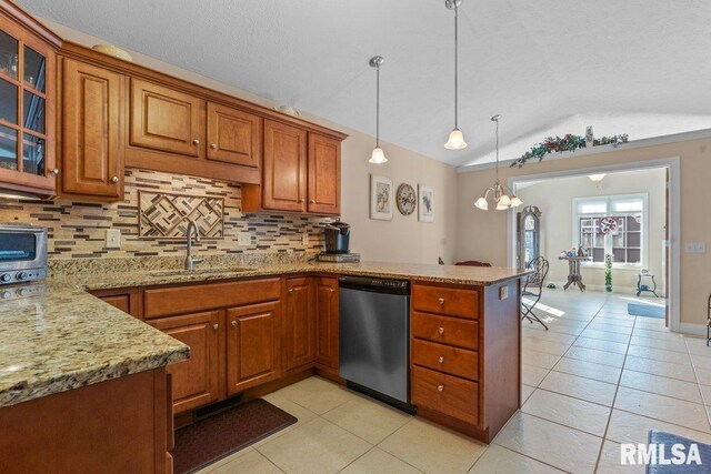 kitchen with brown cabinetry, vaulted ceiling, a sink, dishwasher, and a peninsula