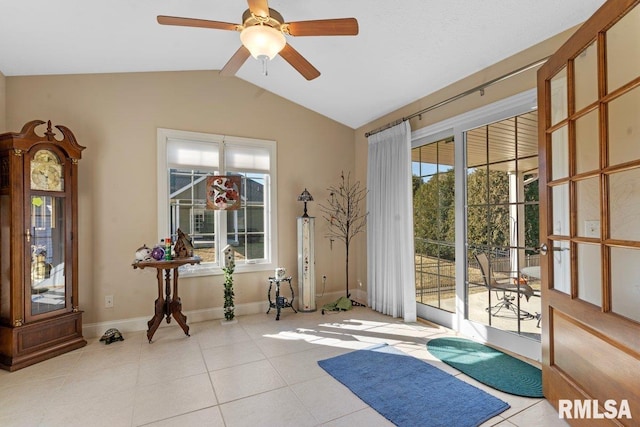 exercise room with ceiling fan, vaulted ceiling, baseboards, and tile patterned floors