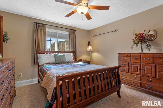 carpeted bedroom featuring a textured ceiling, ceiling fan, and baseboards