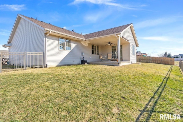 rear view of house featuring a yard, a patio area, a fenced backyard, and ceiling fan