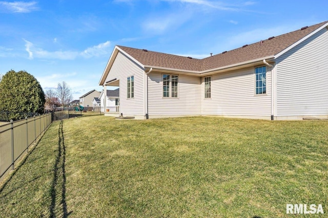 back of house featuring a fenced backyard and a lawn