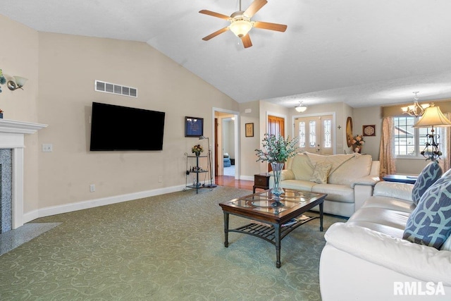 carpeted living room featuring visible vents, a high end fireplace, vaulted ceiling, baseboards, and ceiling fan with notable chandelier