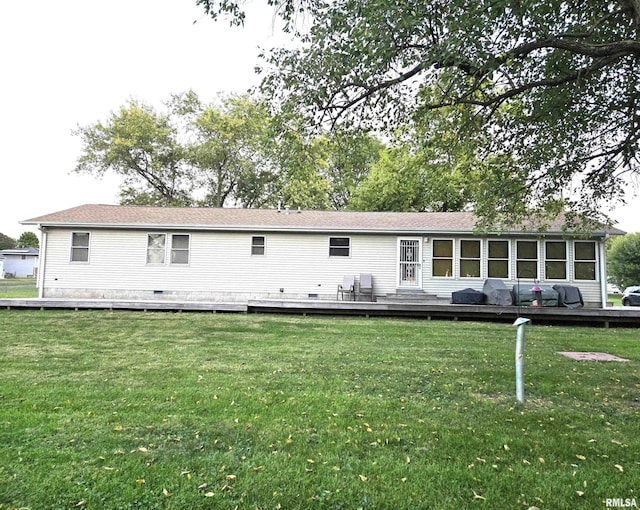 rear view of property with a lawn and a deck