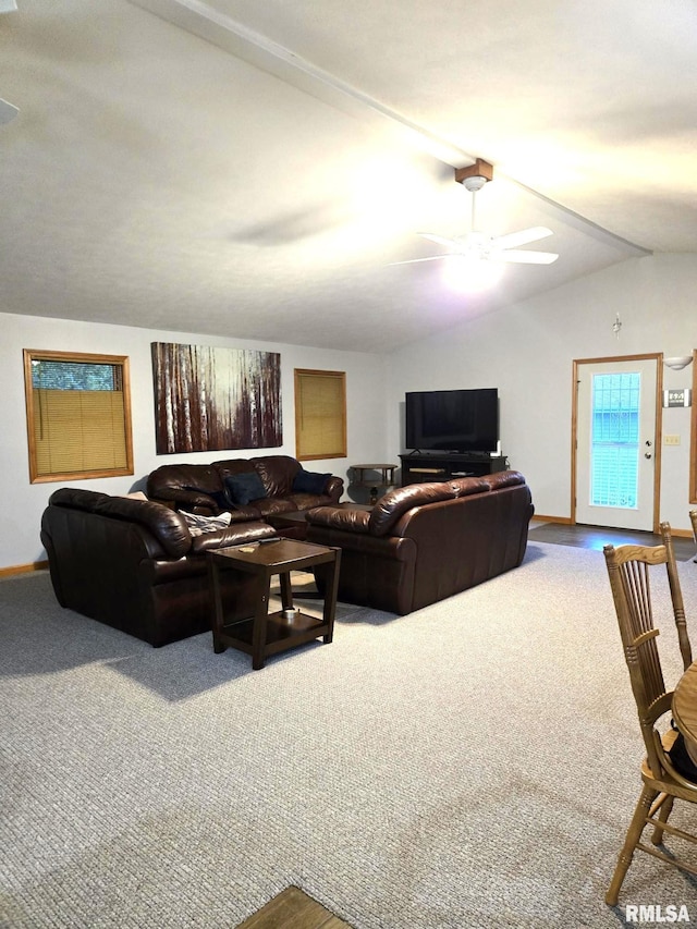 carpeted living room featuring vaulted ceiling, baseboards, and ceiling fan