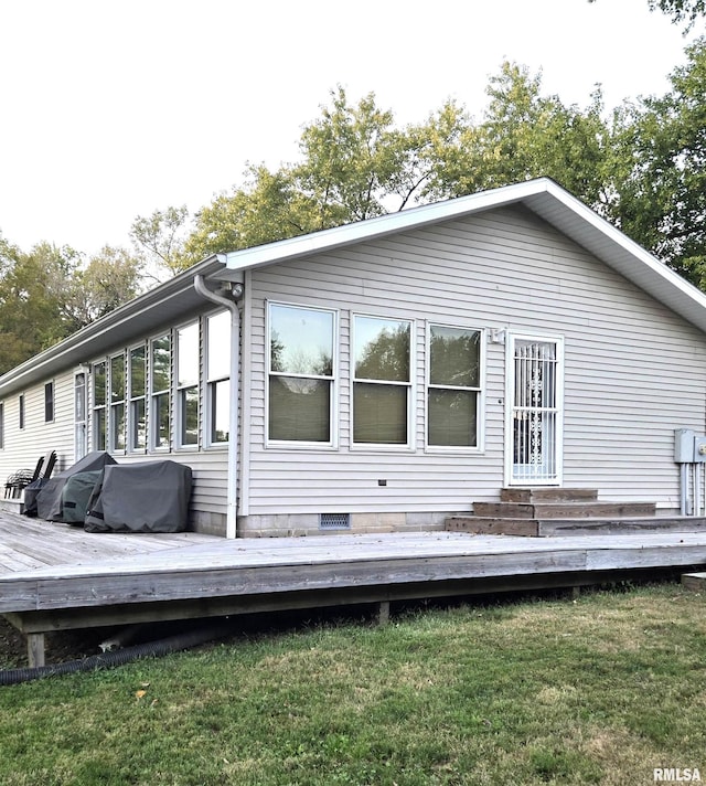 back of property featuring crawl space, a lawn, and a deck