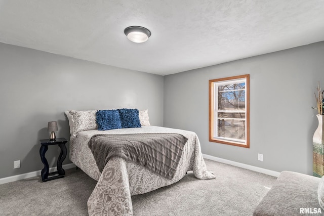 bedroom featuring carpet flooring and baseboards