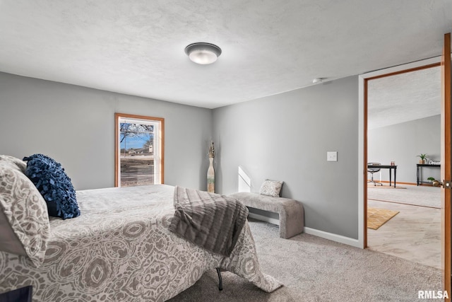 bedroom with carpet floors, baseboards, and a textured ceiling