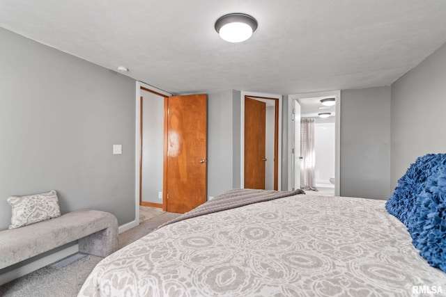 bedroom featuring carpet and baseboards