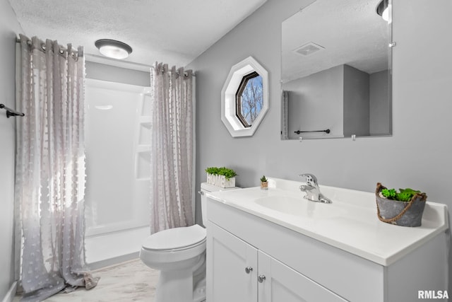 full bathroom with marble finish floor, a textured ceiling, toilet, and vanity