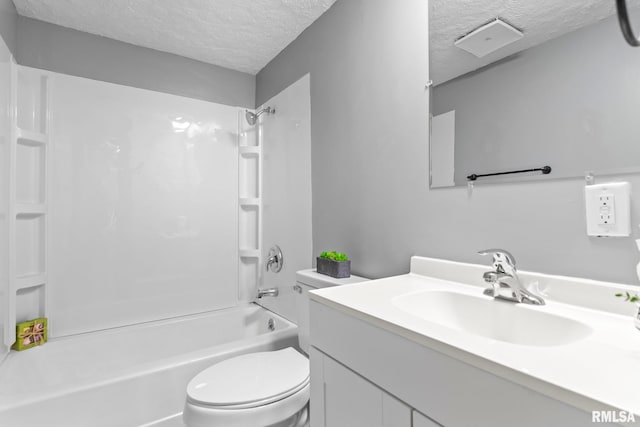 bathroom featuring a textured ceiling, vanity, bathtub / shower combination, and toilet