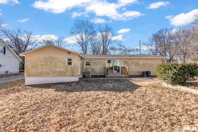 rear view of property featuring central AC unit