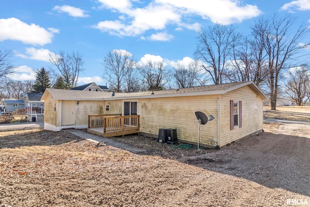 back of house with a deck