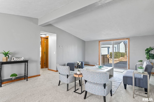 living area featuring vaulted ceiling with beams, a textured ceiling, carpet, and baseboards