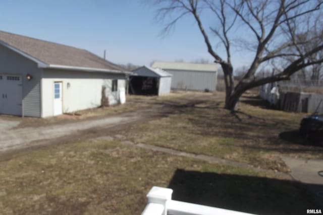 view of side of home with an outbuilding, driveway, and an attached garage