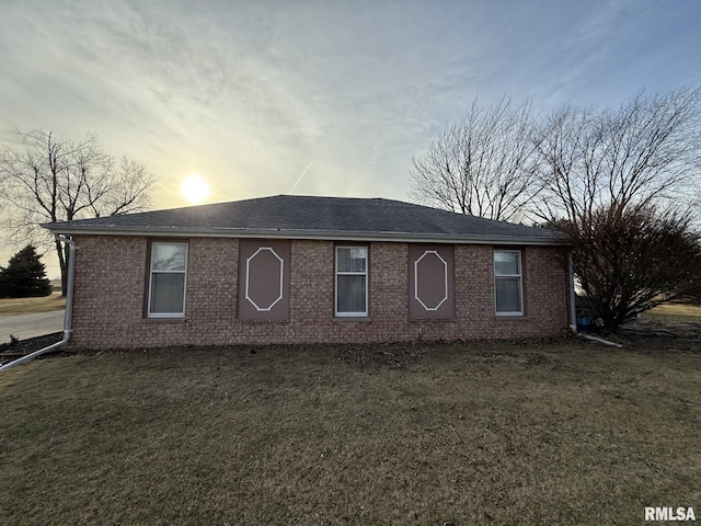 single story home with brick siding and a front lawn