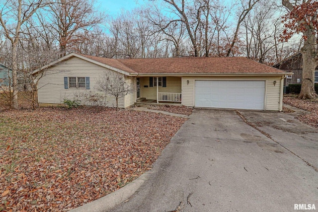 ranch-style home featuring an attached garage, covered porch, and concrete driveway