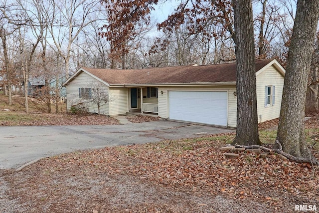 single story home with a garage and driveway