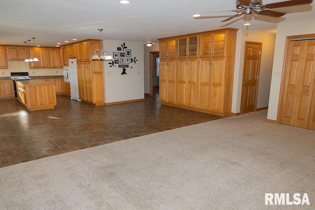 interior space with recessed lighting, dark carpet, and range with electric stovetop