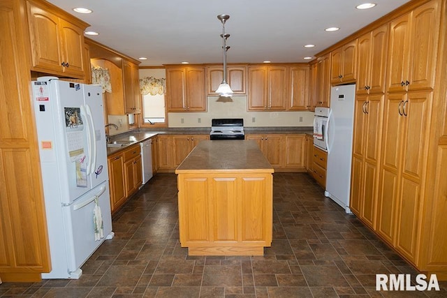 kitchen with recessed lighting, stone finish flooring, a sink, a kitchen island, and white appliances