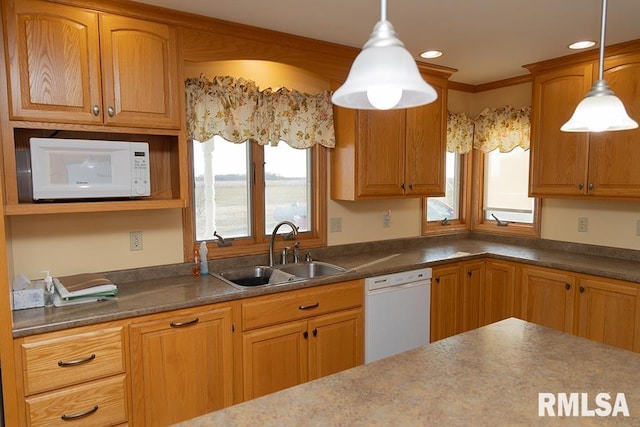 kitchen featuring recessed lighting, white appliances, a sink, dark countertops, and decorative light fixtures