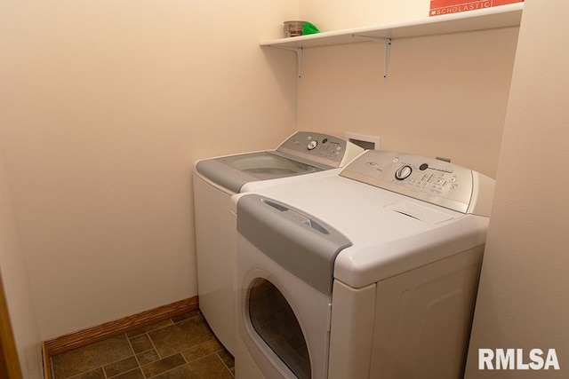 laundry area featuring laundry area, baseboards, and separate washer and dryer