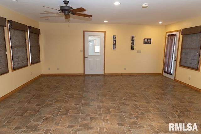 spare room featuring a ceiling fan, recessed lighting, stone finish floor, and baseboards