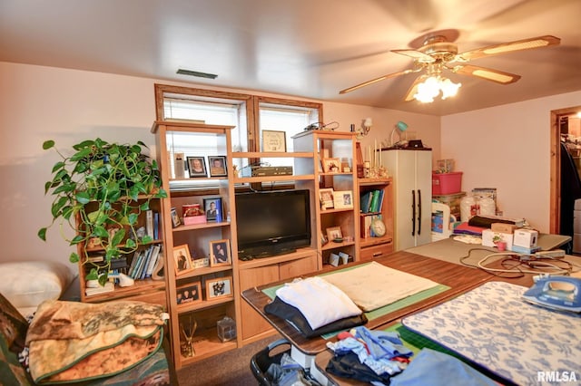 interior space with visible vents and a ceiling fan