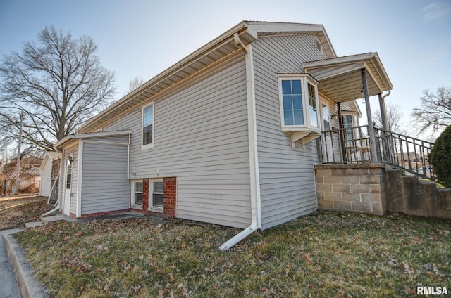 view of side of home featuring a lawn