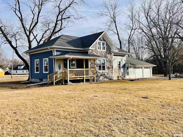 view of front of house featuring covered porch, a front yard, and a garage