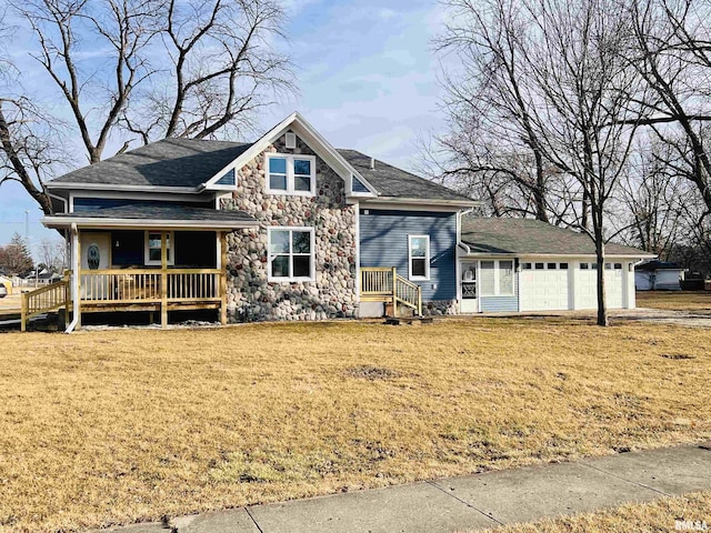 view of front facade with a garage, stone siding, a porch, and a front lawn