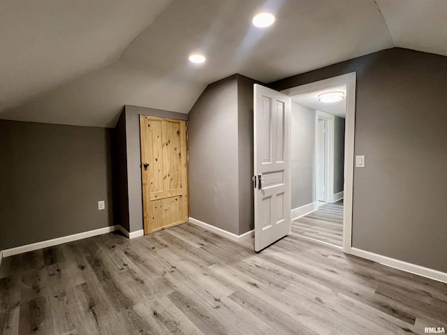 bonus room with lofted ceiling, recessed lighting, wood finished floors, and baseboards