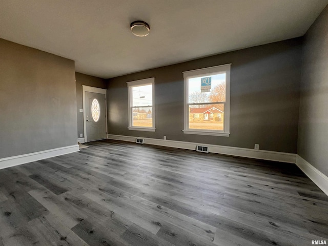 interior space featuring visible vents, baseboards, and wood finished floors