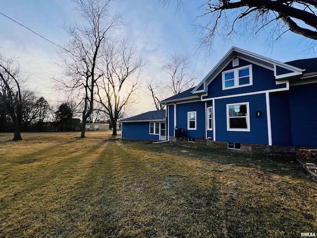 view of property exterior featuring a lawn