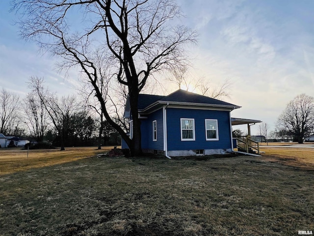 view of side of property with a yard