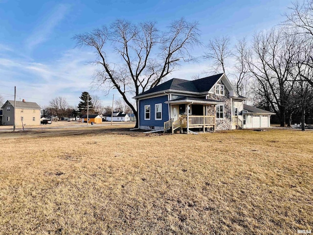 exterior space with covered porch and a yard