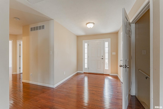 entryway featuring visible vents, baseboards, and hardwood / wood-style flooring