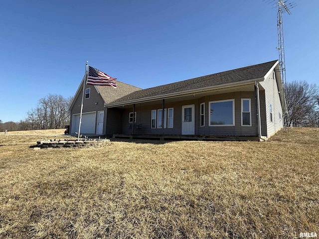 view of front of home with a garage and a front lawn