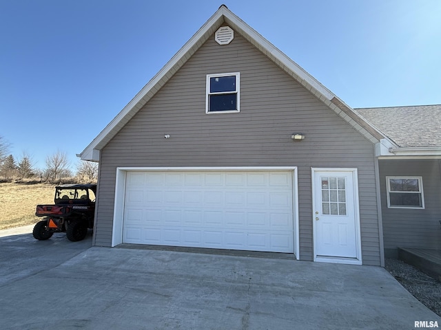 garage featuring concrete driveway