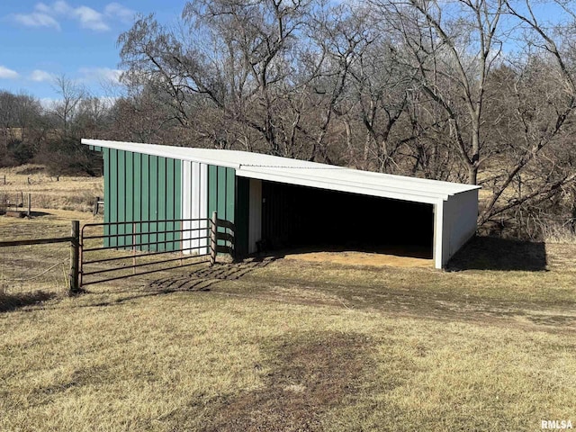 view of outbuilding with fence and an outbuilding