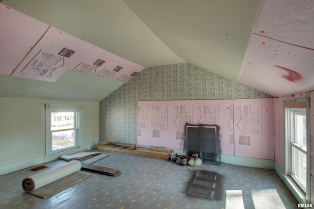 bonus room featuring lofted ceiling, plenty of natural light, and visible vents